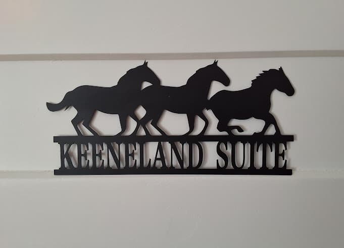 Laser-cut metal sign featuring running horses and the words Keeneland Suite.