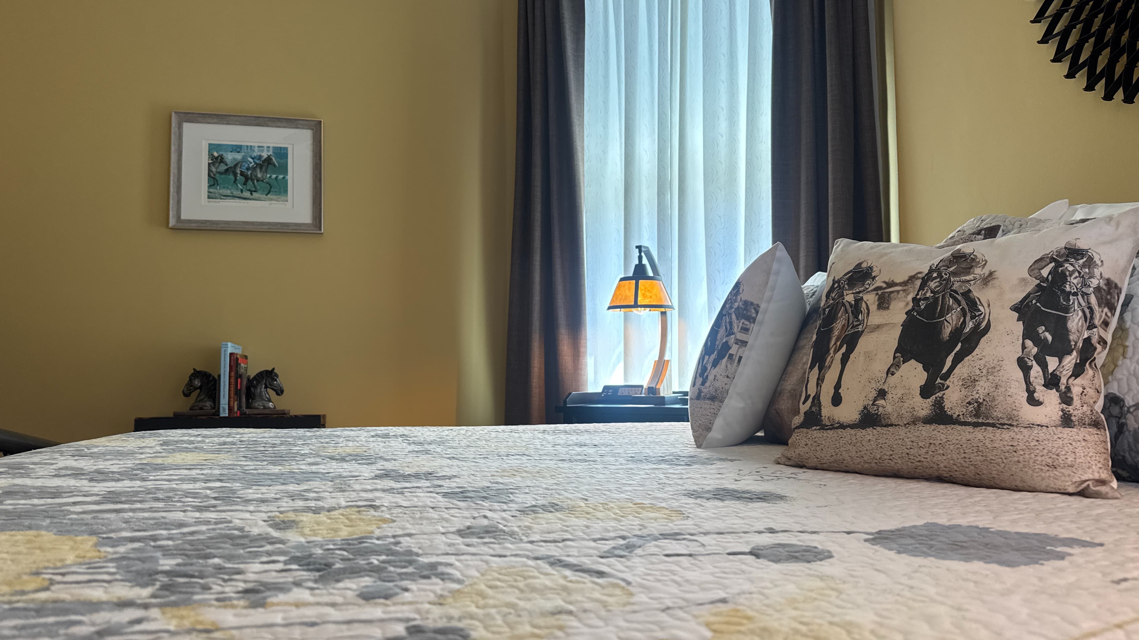 View of the Belmont Suite across the bed toward the eastern window