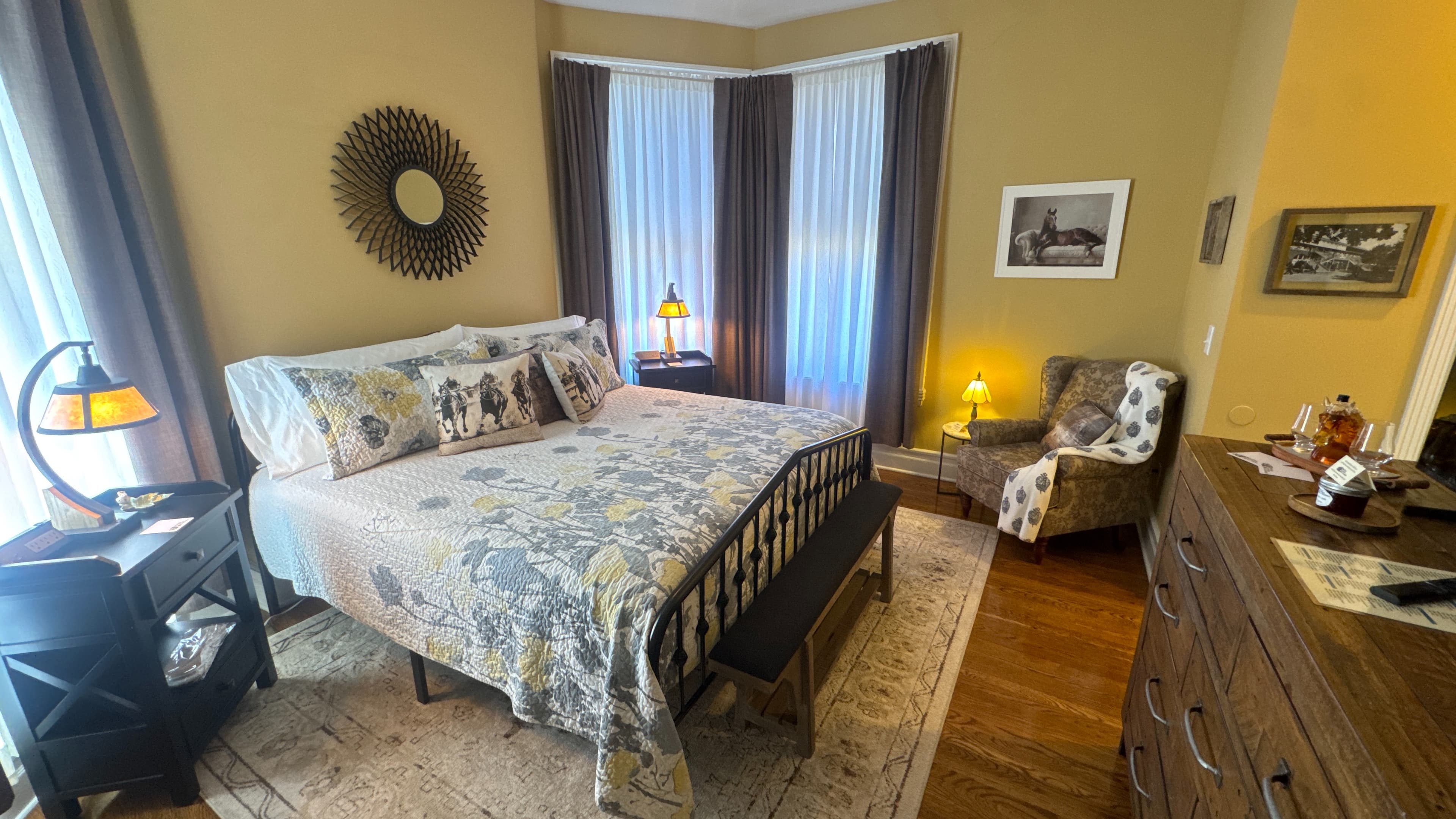 Cozy corner in bedroom with upholstered floral armchair.