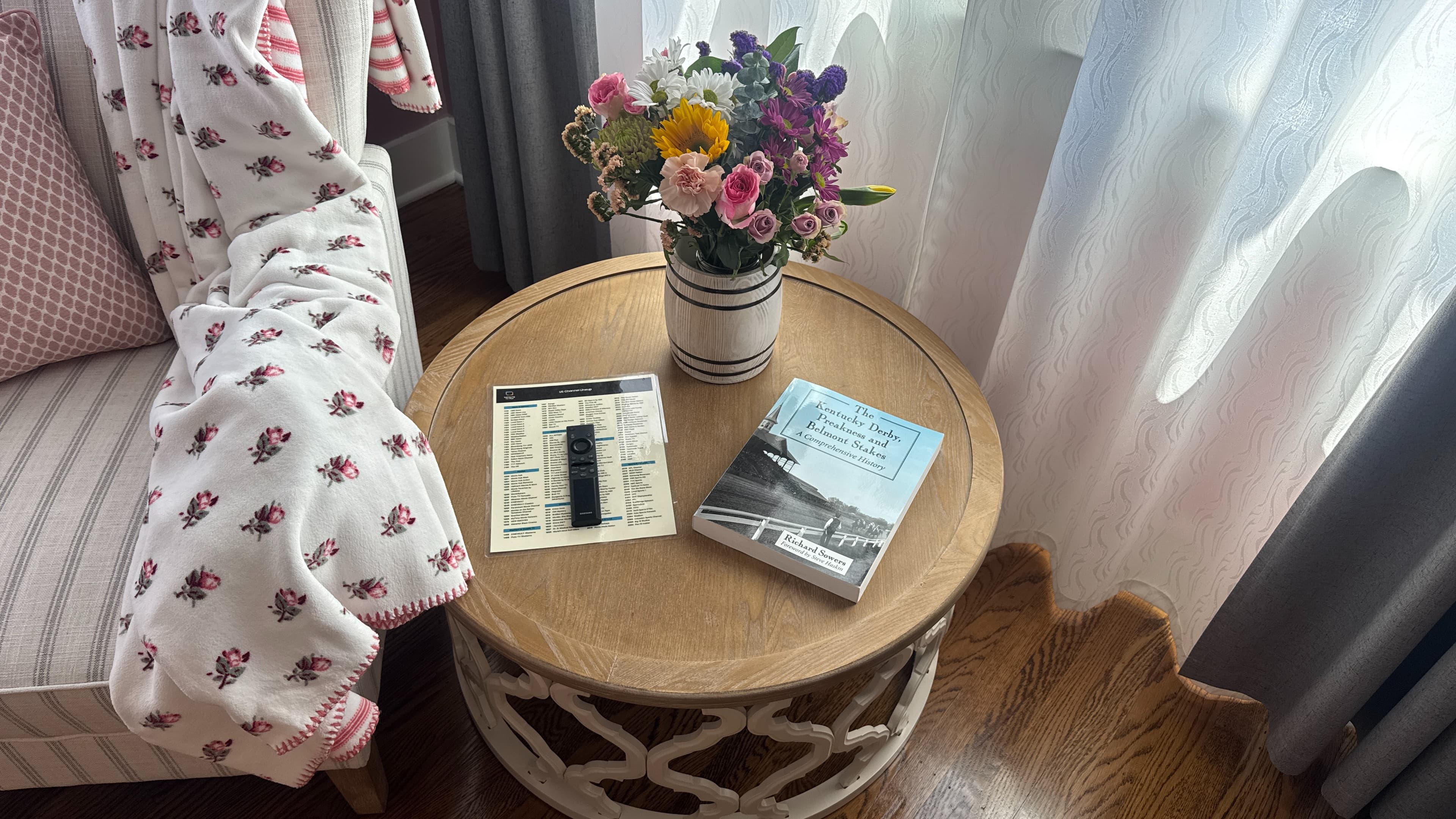 Detail of side table in sitting area with History of Kentucky Derby book and flowers